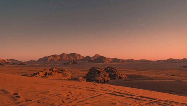 brown sand under blue sky during night time